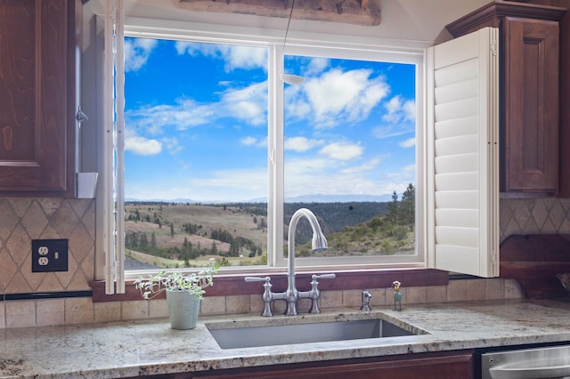 14410 W Jacobs Rd, Spokane, WA 99224 - kitchen view of a sink, dishwasher, light stone counters, and backsplash