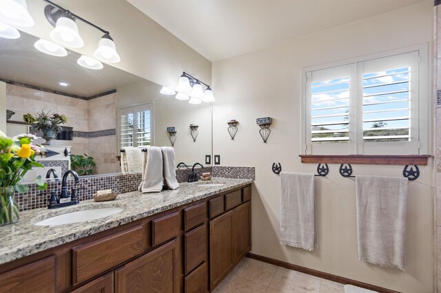 14410 W Jacobs Rd, Spokane, WA 99224 - bathroom featuring double vanity, a walk in shower, tasteful backsplash, baseboards, and tile patterned floors