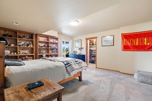 14410 W Jacobs Rd, Spokane, WA 99224 - bedroom featuring light carpet, baseboards, a walk in closet, and access to exterior