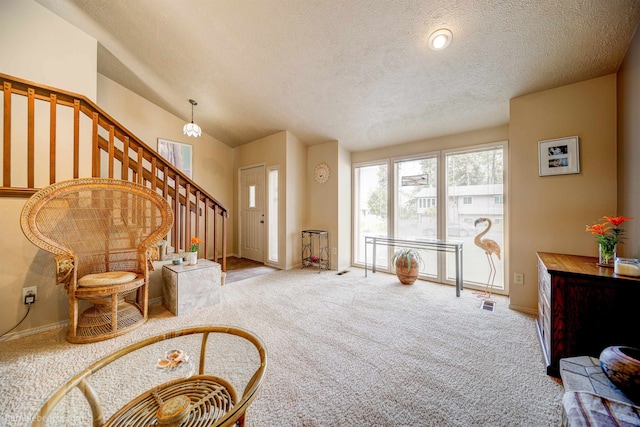4112 E 11th Ave, Spokane, WA 99202 - carpeted foyer entrance with a textured ceiling, stairs, and baseboards