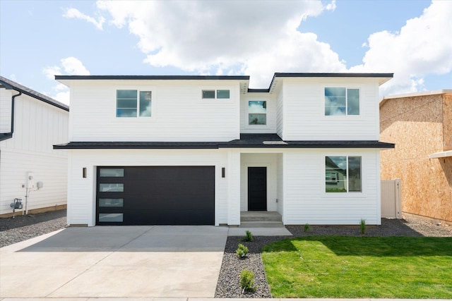 2077 W Walker Ave, Spokane, WA 99208 - view of front of home featuring a garage, concrete driveway, and a front lawn