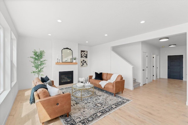 2077 W Walker Ave, Spokane, WA 99208 - living room with wood finished floors, stairway, a fireplace, and recessed lighting