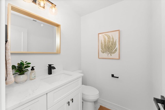 2077 W Walker Ave, Spokane, WA 99208 - bathroom with toilet, vanity, baseboards, and tile patterned floors