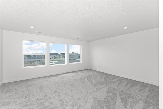 2077 W Walker Ave, Spokane, WA 99208 - carpeted empty room with recessed lighting, a textured ceiling, and baseboards