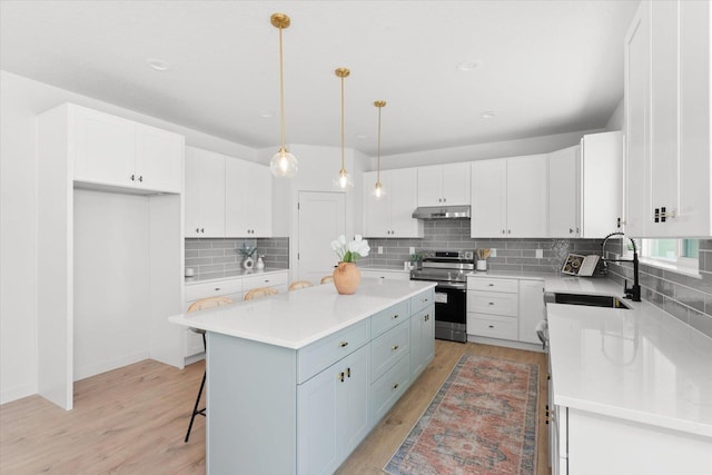 2077 W Walker Ave, Spokane, WA 99208 - kitchen with stainless steel electric range, a sink, a kitchen island, white cabinetry, and recessed lighting