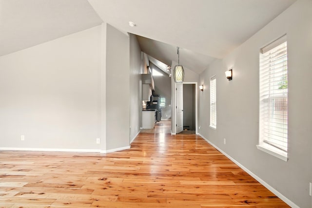 3016 N Walnut Street On A Dead End Street, Spokane, WA 99205 - unfurnished living room with lofted ceiling, light wood-style floors, and baseboards