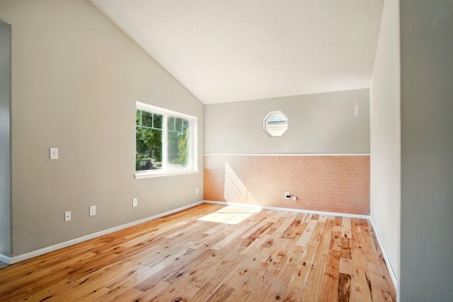 3016 N Walnut Street On A Dead End Street, Spokane, WA 99205 - unfurnished room featuring wood-type flooring, vaulted ceiling, and baseboards