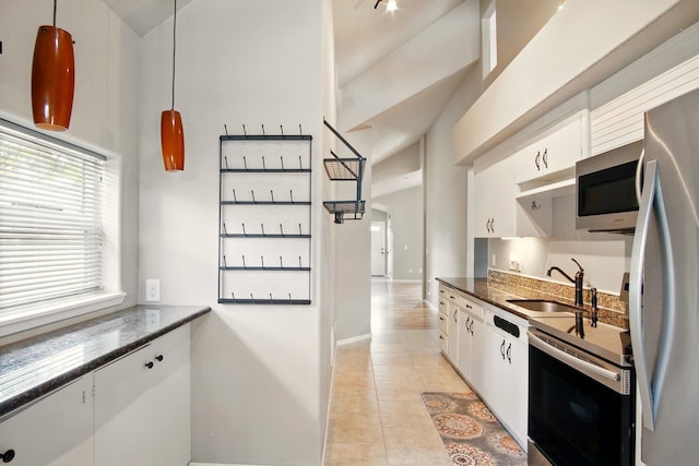 3016 N Walnut Street On A Dead End Street, Spokane, WA 99205 - kitchen with appliances with stainless steel finishes, white cabinetry, a sink, baseboards, and light tile patterned floors
