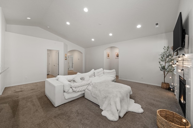 2026 W Parkway Ct, Spokane, WA 99208 - carpeted living room with arched walkways, vaulted ceiling, a tiled fireplace, recessed lighting, and baseboards