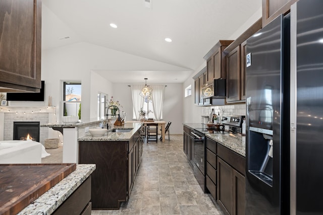 2026 W Parkway Ct, Spokane, WA 99208 - kitchen with stainless steel fridge with ice dispenser, black range with electric cooktop, lofted ceiling, dark brown cabinets, and a sink