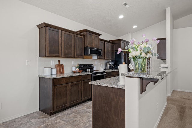 2026 W Parkway Ct, Spokane, WA 99208 - kitchen featuring electric range, a kitchen bar, dark brown cabinets, baseboards, and a peninsula