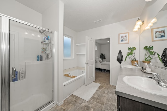 2026 W Parkway Ct, Spokane, WA 99208 - ensuite bathroom featuring double vanity, a bath, a stall shower, and stone finish floors