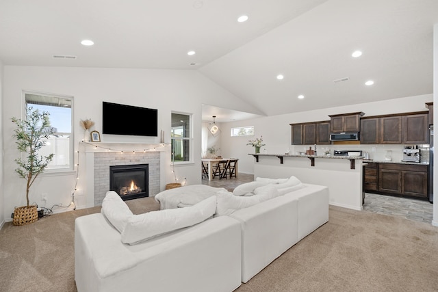2026 W Parkway Ct, Spokane, WA 99208 - living area with light carpet, lofted ceiling, recessed lighting, and a brick fireplace