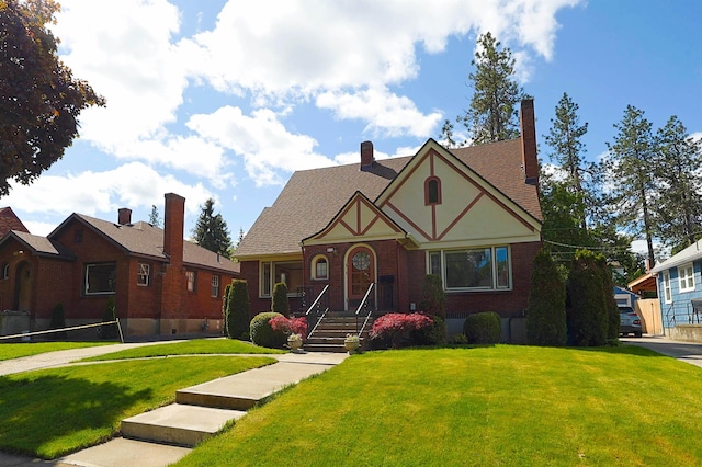 417 W 26th Ave, Spokane, WA 99203 - tudor house with a front lawn, a chimney, brick siding, and stucco siding