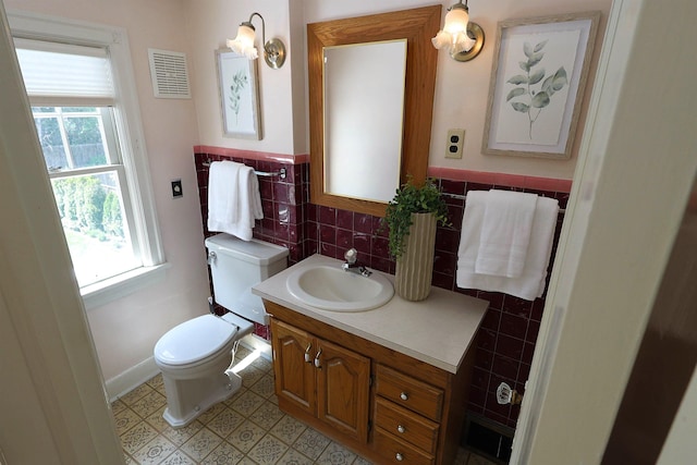 417 W 26th Ave, Spokane, WA 99203 - bathroom with toilet, vanity, tile walls, and baseboards