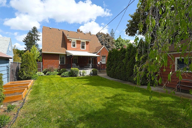 417 W 26th Ave, Spokane, WA 99203 - rear view of house with a vegetable garden and brick siding