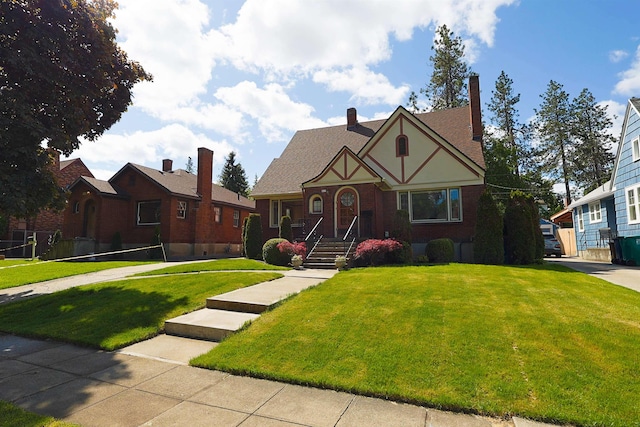 417 W 26th Ave, Spokane, WA 99203 - english style home featuring a front lawn and a chimney