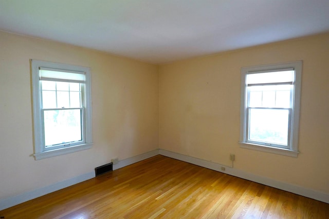 417 W 26th Ave, Spokane, WA 99203 - empty room with healthy amount of natural light, light wood-type flooring, and baseboards