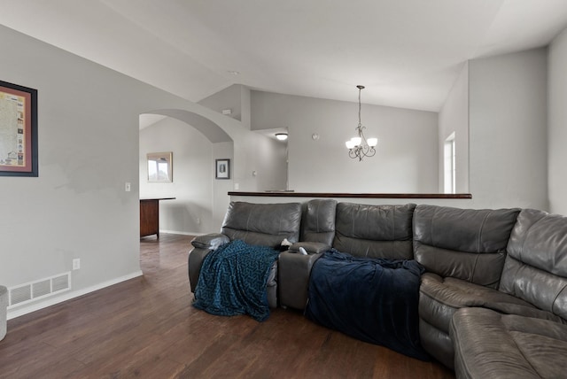 8710 N I Ct, Spokane, WA 99208 - living area with arched walkways, vaulted ceiling, dark wood-style flooring, baseboards, and a chandelier