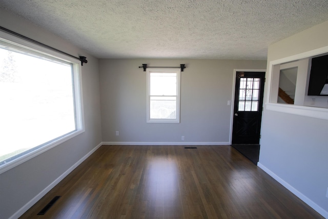 5512 N G St, Spokane, WA 99205 - empty room featuring plenty of natural light, dark wood finished floors, a textured ceiling, and baseboards
