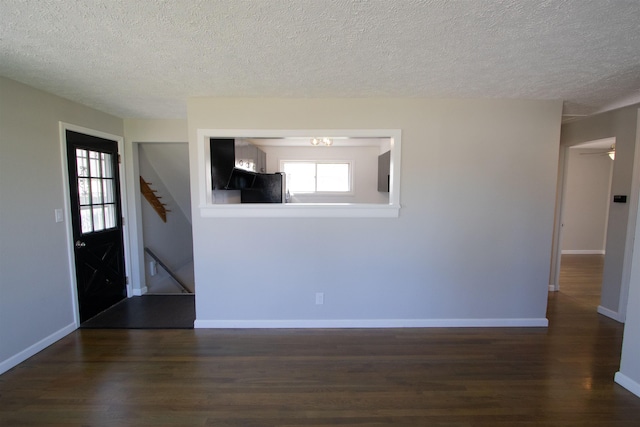 5512 N G St, Spokane, WA 99205 - unfurnished living room featuring a textured ceiling, wood finished floors, stairs, and baseboards