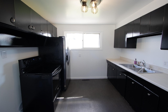 5512 N G St, Spokane, WA 99205 - kitchen featuring black / electric stove, dark cabinets, a sink, light countertops, and baseboards