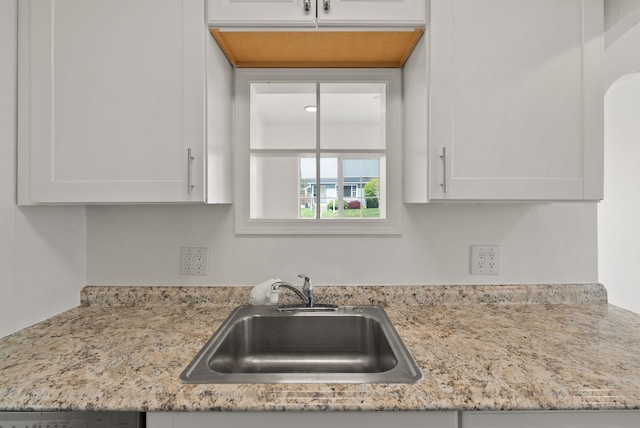 3215 W Longfellow Ave, Spokane, WA 99205 - kitchen featuring a sink, white cabinetry, light stone counters, and dishwashing machine