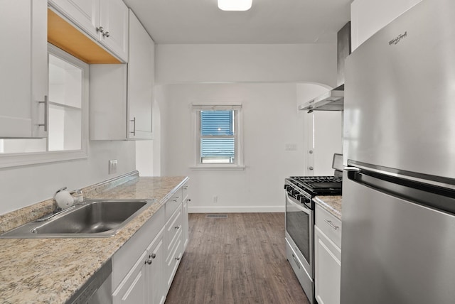 3215 W Longfellow Ave, Spokane, WA 99205 - kitchen featuring appliances with stainless steel finishes, a sink, light countertops, dark wood-type flooring, and white cabinets