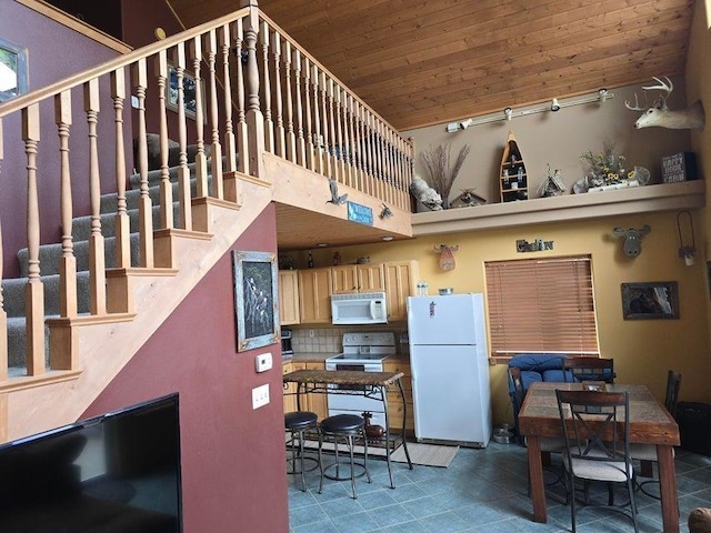 278 Hazel St, Cusick, WA 99119 - kitchen featuring white appliances, wood ceiling, a towering ceiling, tile patterned floors, and light brown cabinetry