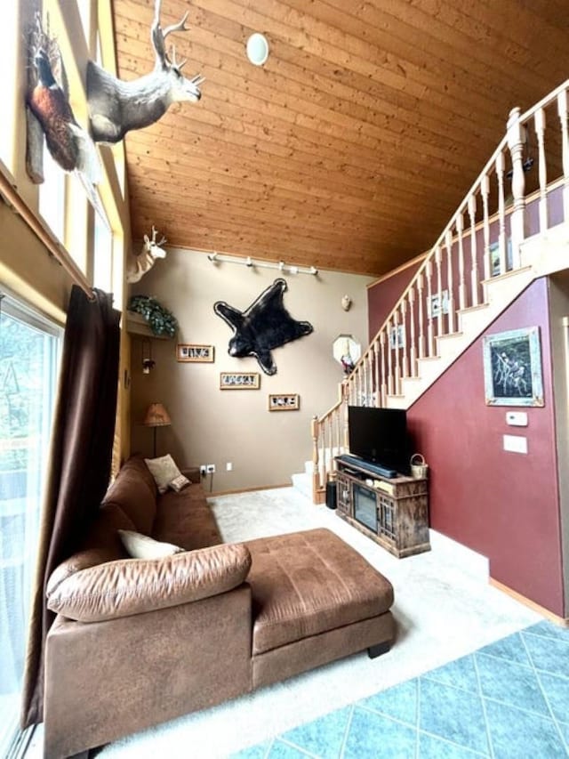 278 Hazel St, Cusick, WA 99119 - carpeted living room with wooden ceiling, stairway, high vaulted ceiling, baseboards, and rail lighting