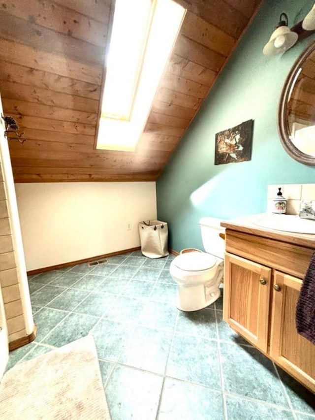 278 Hazel St, Cusick, WA 99119 - full bath featuring wooden ceiling, vaulted ceiling, a skylight, vanity, and toilet