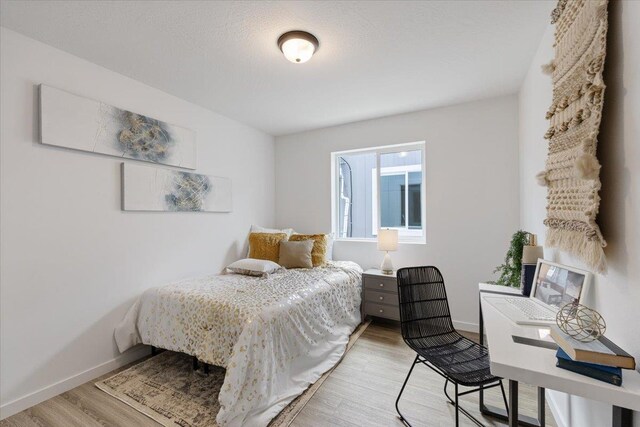 1912 W Buckeye Ave, Spokane, WA 99205 - bedroom featuring light wood-style flooring, an office area, and baseboards
