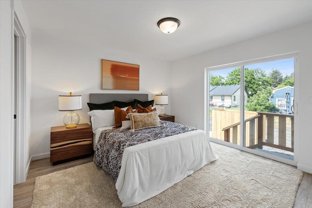 1912 W Buckeye Ave, Spokane, WA 99205 - bedroom with access to exterior, wood finished floors, and baseboards