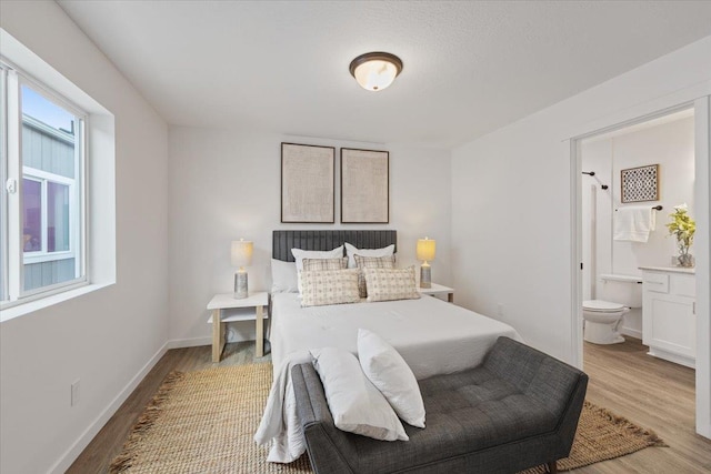 1912 W Buckeye Ave, Spokane, WA 99205 - bedroom with light wood-style flooring, ensuite bathroom, and baseboards