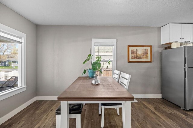 4824 N Stone St, Spokane, WA 99207 - dining area featuring dark wood-type flooring and baseboards