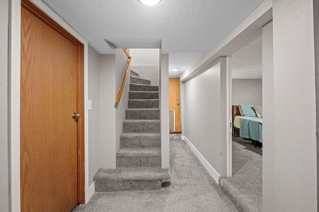 4824 N Stone St, Spokane, WA 99207 - staircase featuring carpet floors, baseboards, and a textured ceiling