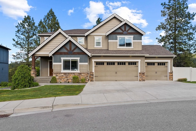 13408 E Copper River Ln, Spokane, WA 99206 - craftsman house with stone siding, driveway, an attached garage, and roof with shingles