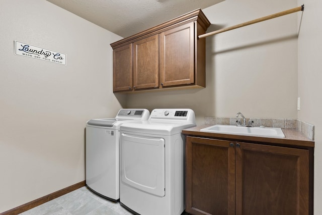 13408 E Copper River Ln, Spokane, WA 99206 - laundry area with washing machine and clothes dryer, cabinet space, and baseboards