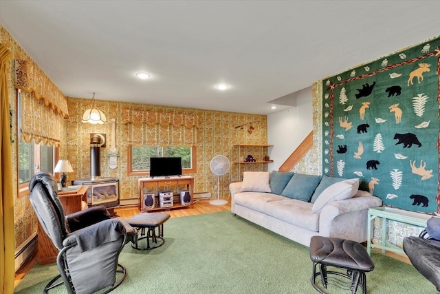 4134 Pebble Beach Rd, Loon Lake, WA 99148 - living area featuring a wood stove, wood finished floors, a baseboard heating unit, a baseboard radiator, and recessed lighting