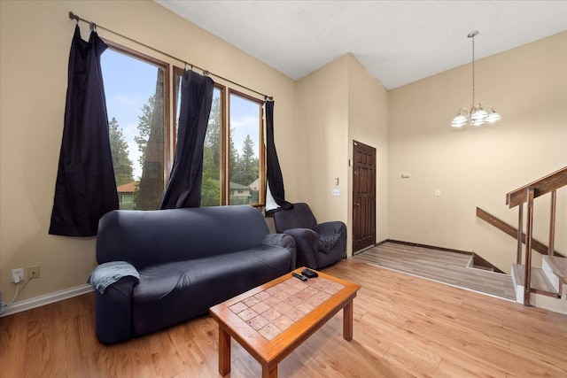 3712 E 12th Ave, Spokane, WA 99202 - living room with baseboards, light wood-type flooring, and a chandelier