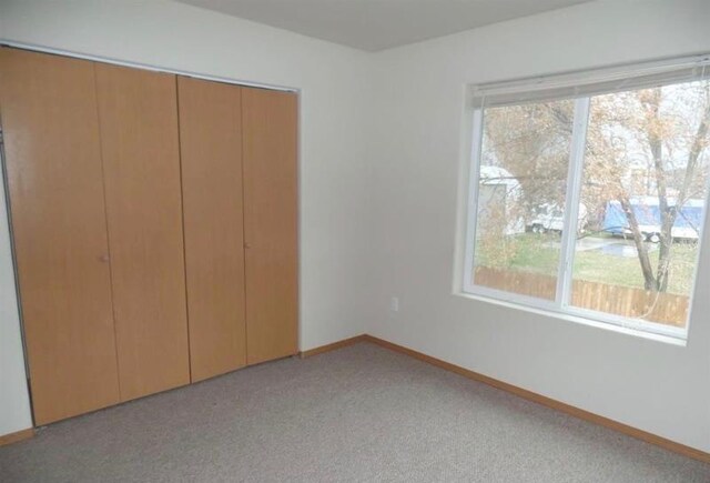 310 S Union St Unit 312, Spokane Valley, WA 99206 - unfurnished bedroom featuring a closet, light colored carpet, and baseboards