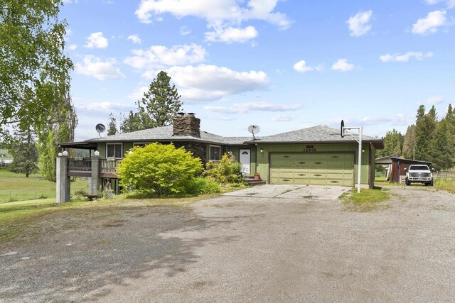 15906 N Forker Rd, Spokane, WA 99217 - single story home with dirt driveway, a garage, a chimney, and a carport