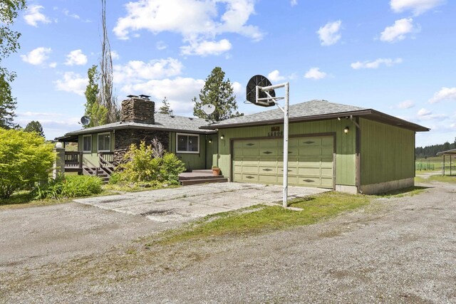 15906 N Forker Rd, Spokane, WA 99217 - view of front facade featuring driveway, an attached garage, and a chimney