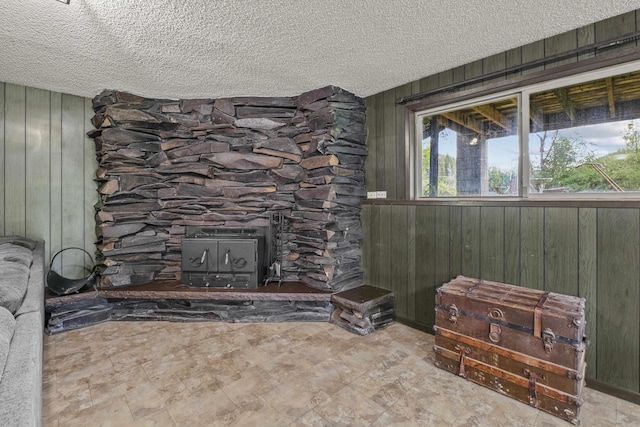 15906 N Forker Rd, Spokane, WA 99217 - living room with wooden walls, a textured ceiling, and a wood stove