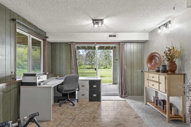 15906 N Forker Rd, Spokane, WA 99217 - office area with wood walls, a textured ceiling, and stone finish flooring