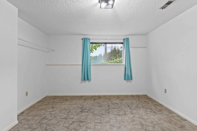 15906 N Forker Rd, Spokane, WA 99217 - spare room with a textured ceiling and baseboards