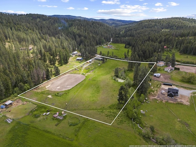 15906 N Forker Rd, Spokane, WA 99217 - aerial view of property and surrounding area featuring a forest, property parcel outlined, and a mountain backdrop