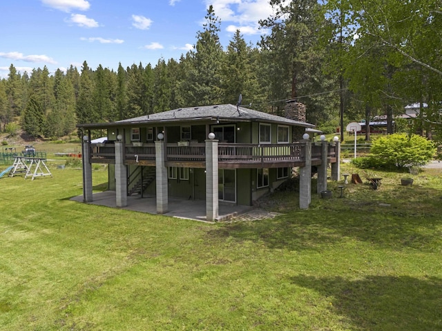 15906 N Forker Rd, Spokane, WA 99217 - back of property with a patio, a chimney, a wooden deck, a lawn, and stairway