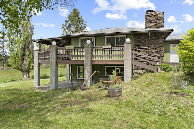 15906 N Forker Rd, Spokane, WA 99217 - rear view of house with a wooden deck, a chimney, stone siding, and a shingled roof