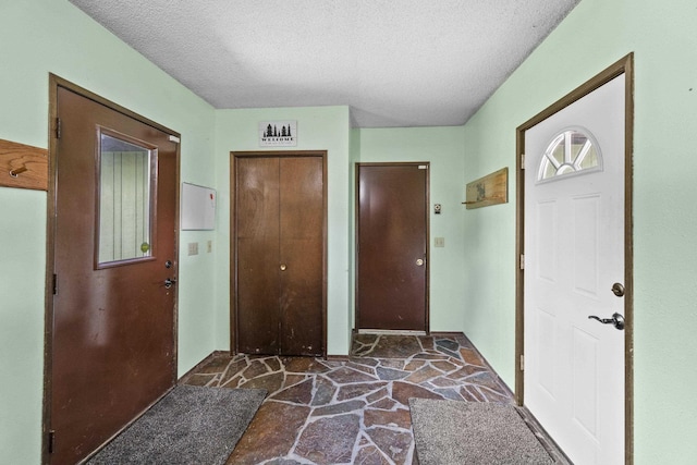 15906 N Forker Rd, Spokane, WA 99217 - foyer with stone floors and a textured ceiling